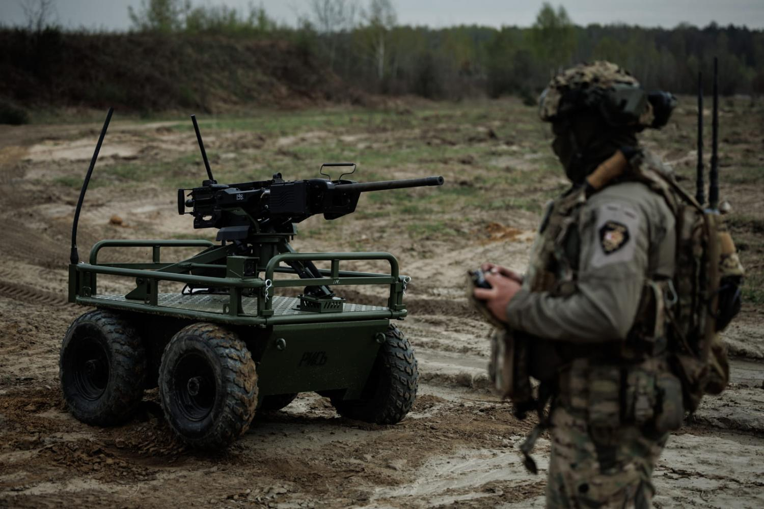 Silhouette of a soldier launching a reconnaissance drone at dawn.